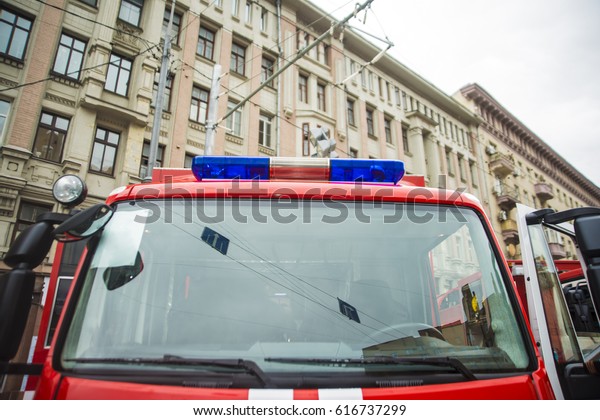 russian fire\
service truck stands on street building background , september\
2016.blue car siren stand on  Fire service\
