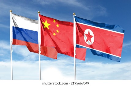 Russian Flag With Chinese Flag And North Korean Flag On Cloudy Sky. Waving In The Sky