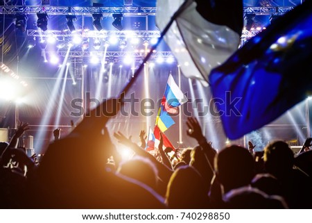 Russian flag at the concert, opposite the light from the stage