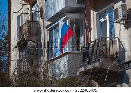 Russian flag on a balcony in Simferopol city in Crimea peninsula, Ukrainian territory occupied by Russian