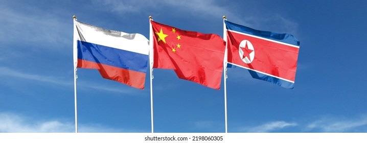 Russian Flag On Cloudy Sky With Chinese Flag And North Korean Flag. Waving In The Sky