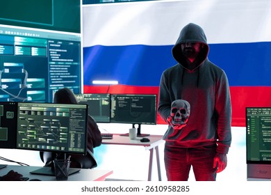 Russian hackers creating dark web maniac cybercrime in a control room, sinister man holding a skull hinting at death threats. Aggressive harmful criminal activity, cyber terrorism.