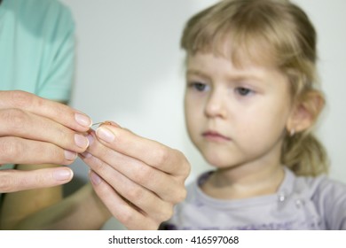 Russian Little Girl Is Having An Art Lesson Which Entitled Bad Hair Day. The Girl Is Looking How To Bend A Metal Wire.