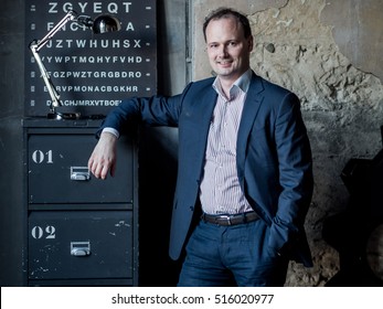 Russian Man In A Suit On Old Peeling Wall In Grunge Style