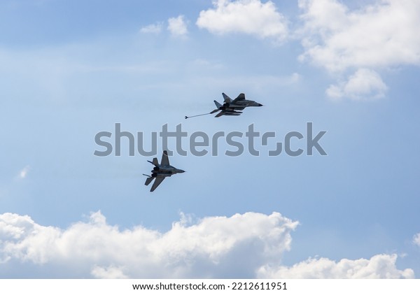 Russian MiG-29 multirole fighter jet and\
(NATO-Fulcrum) MiG-35 fighter jet demonstrate aerial refueling over\
airfield of Gromov Flight Research Institute. Zhukovsky, Russia -\
August 19, 2011