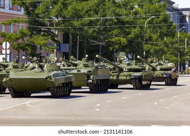 Russian military vehicles on the city street. Russian modern military tank, infantry fighting vehicle BMP and armored personnel carrier BTR.