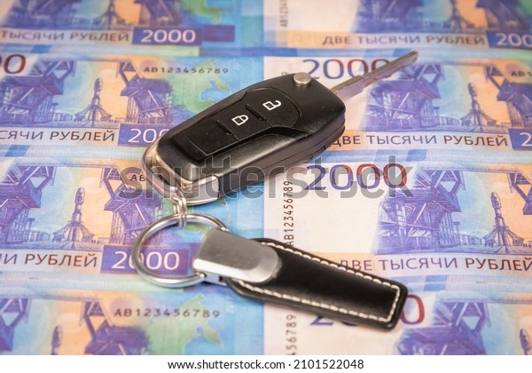 Russian money and car keys. Deal for the sale,\
purchase of a car. Car\
rent.