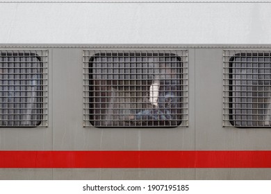 Russian National Guard Officer Inside Of Riot Police Truck Window Behind Metal Grate