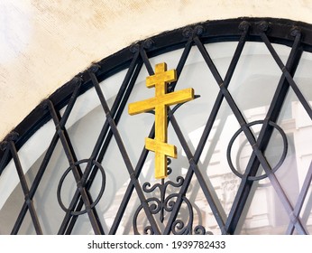 Russian Orthodox wooden cross symbol on a metal gate closeup, detail shot. Eastern Orthodox Christianity religious symbols concept, faith, belief, nobody