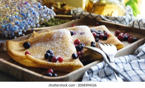 Russian Pancakes With Berries On A Wooden Dish. Still Life Of Food. Nuts Pancakes Sprinkled With Fork Spoon. Wooden Dishes. Food Aesthetics. Breakfast
