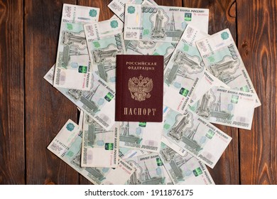 Russian Passport With Money For Shopping Abroad, Travel And Entertainment. Money Is Lying On Wooden Background.