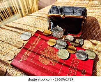 Russian passport and small money on the table. Rubles and euros. Concept of poverty among Russians. Foreign travel is too expensive for Russian citizens - Shutterstock ID 2366962739