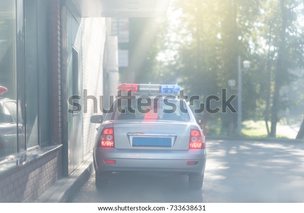 Russian police car with colorful lights on top.\
Blurred beam lights