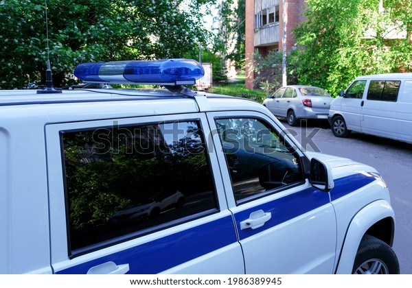 Russian police car. The inscription on the car door\
is made in Russian. Close-up of blue lights on the roof of a\
Russian police car.