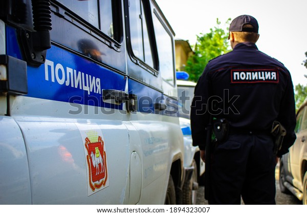 Russian policeman near a patrol car.\
Translation: \