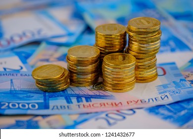 Russian Rubles In Coins On Banknotes Background.