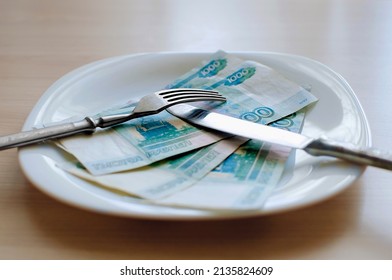 Russian rubles on a white plate, Close-up, selective focus. Keep money on the fork. Minimum subsistence level, food basket, minimum wage. Concept. Eat money, living wage. Economy. Crisis, inflation - Shutterstock ID 2135824609