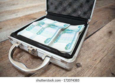 Russian Rubles In Order Inside Of Steel Suitcase, On Wooden Floor