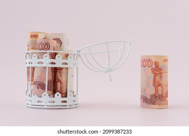 Russian Rubles Are Peeking Out Of An Open Cage. The Concept Of Investment. Free Money Circulation. Tax Exemption. Free Economic Zone.