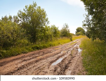 Russian rural landscape with empty countryside dirt wet road