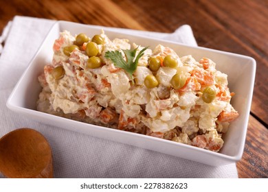 Russian Salad, also known as Oliver Salad. Very popular dish in several countries, the main ingredients are commonly potatoes, mayonnaise and vegetables such as peas, carrots, boiled eggs or chicken. - Shutterstock ID 2278382623