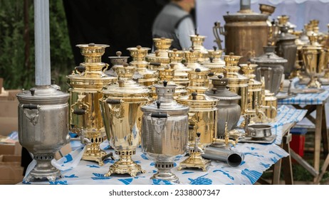 Russian samovars stand on the table for sale. Bronze samovar.