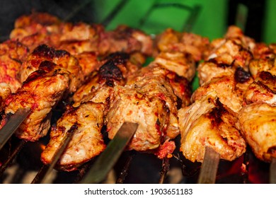 Russian shashlik with skewers on a round grill in Norway. - Shutterstock ID 1903651183
