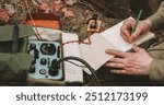 Russian Soviet Infantry Red Army Soldier In World War II using Russian Soviet Portable Radio Transceiver In Trench Entrenchment In Spring Autumn Forest. . Headphones And Telegraph Key. Close Up Hands,