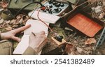 Russian Soviet Infantry Red Army Soldier In World War II using Russian Soviet Portable Radio Transceiver In Trench Entrenchment In Spring Autumn Forest. . Headphones And Telegraph Key. Close Up Hands,