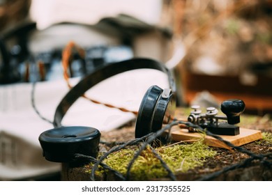 Russian Soviet Portable Radio Transceiver Used By USSR Red Army Signal Corps In World War Ii. Headphones And Telegraph Key Are On A Forest Stump. - Powered by Shutterstock