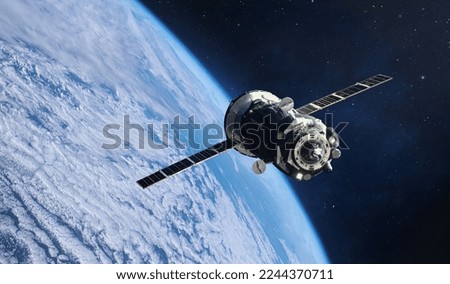 Russian spaceship in space. Cargo spacecraft flight in outer space to space station. Earth orbit with stars. Elements of this image furnished by NASA