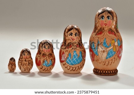 Russian traditional nesting doll set called Matrushka or Babushka with plain background.