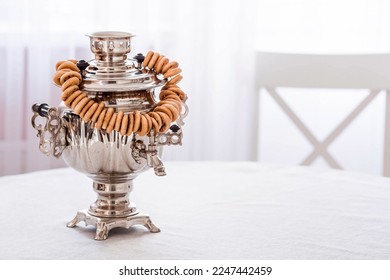 Russian traditions. Tea drinking with a samovar. Still life with bagels, dried fruits and Russian samovars in the interior of a modern white kitchen.
