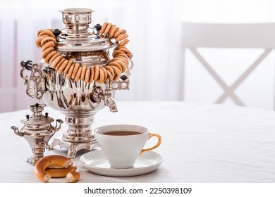 Russian traditions. Tea drinking with a samovar. Still life with a cup of tea, bagels, dried fruits and Russian samovars.
