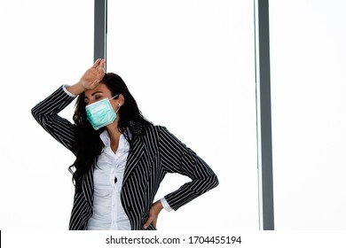 Russian Woman In A Business Attire Wears A Protective Mask And Causes The Hand To Show A Headache.