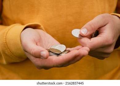 Russian Woman Considers Savings Cash. Only Mans Hands And Money, Yellow Clothes. Concept Of Poor Human. Russian Coins Hold In Hands And Count. Crisis And Economic Downturn.