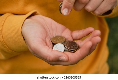 Russian Woman Considers Savings Cash. Only Mans Hands And Money, Yellow Clothes. Concept Of Poor Human. Russian Coins Hold In Hands And Count. Crisis And Economic Downturn.