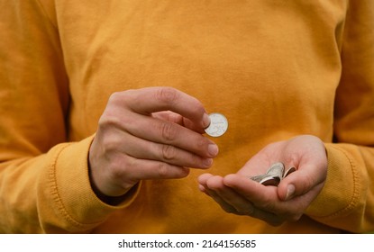 Russian Woman Considers Savings Cash. Only Mans Hands And Money, Yellow Clothes. Concept Of Poor Human. Russian Coins Hold In Hands And Count. Crisis And Economic Downturn.