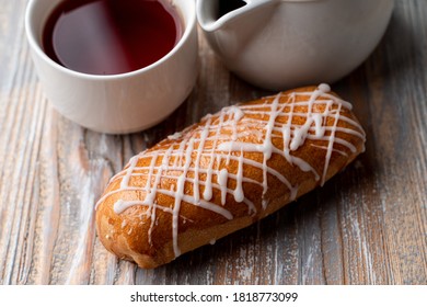 Russian Yeast Dough Bun With White Chocolate Drops And Poppy Filling, Lose Up On A Wooden Background