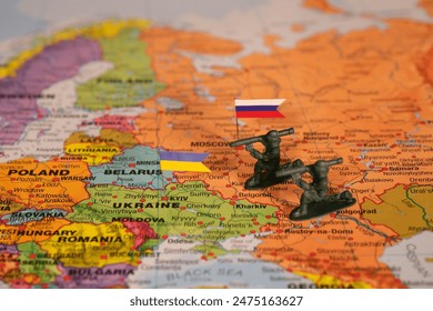 Russia-Ukraine Conflict: Toy Soldiers and Flags on Eastern Europe Map Highlighting Key Conflict Zones. - Powered by Shutterstock