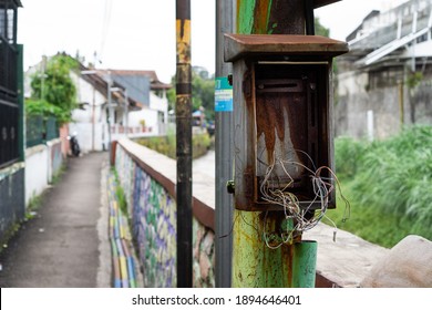 Rust And Broken Electrical Cable Box Cabinet On Metal Power Line Pole.