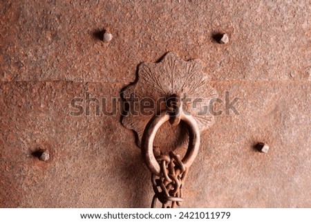 Rust metallic massive door with ring and rusted chain texture