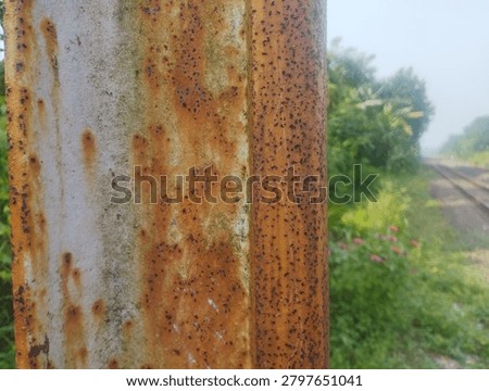 rust on iron against the backdrop of railroad tracks 