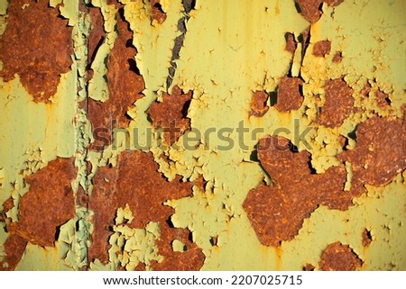 Rust on metal. Texture of rusty layer of iron. Green surface in brown spots.