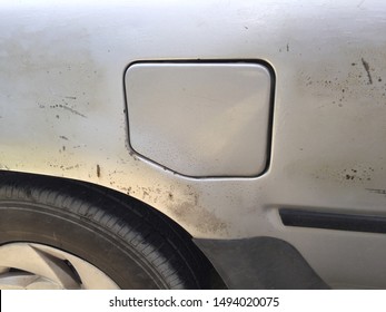 Rust on the side of a metallic  car body near the fuel tank lid - Shutterstock ID 1494020075