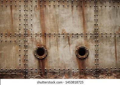 RUST AND TEXTURE ON METAL PLATE SIDES OF STAGED SHIPWRECK WITH RIVETS AND PORTHOLES - Shutterstock ID 1453818725