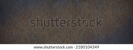 Rust texture. Rough rusty metal surface. Black Brown. Dark grunge background with space for design. Close-up. Web banner. Wide. Panoramic.