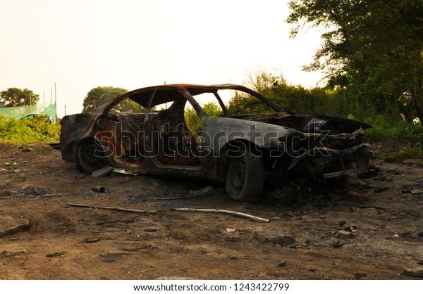 Rusted and burnt out car that has been abandoned.\
Vladivostok, Russia.