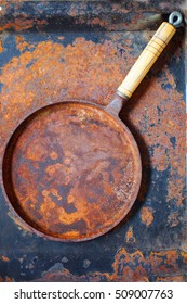 Rusted Cast Iron Pan  On Rust Background, Selective Focus, Top View