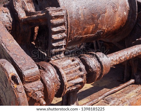 rusted cogs and gears on an old broken industrial machine